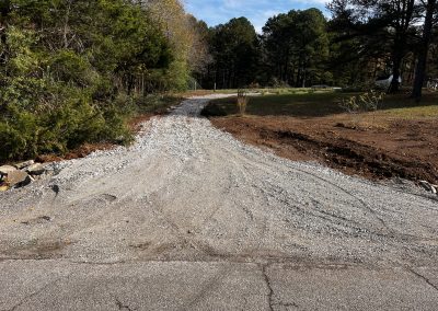 Newly graded gravel driveway prepped for a residential property