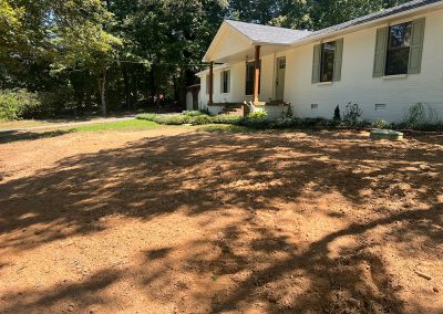 Final grade cleanup on a completed septic tank install.