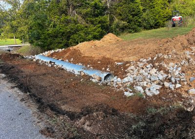 Culvert installed and partially backfilled ahead of driveway grading