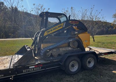Skidsteer loaded up after clearing & grading a residential site for a new driveway